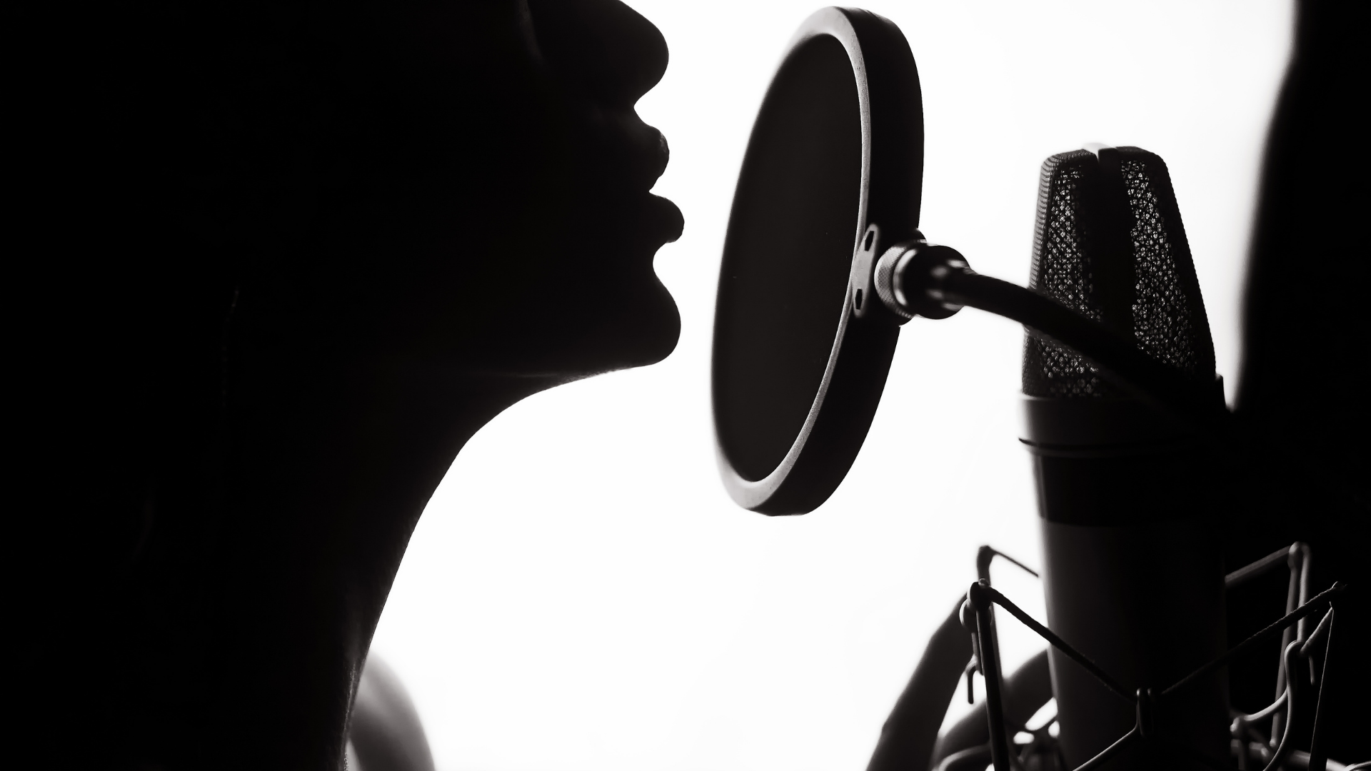 close up silhouette side profile singing into microphone